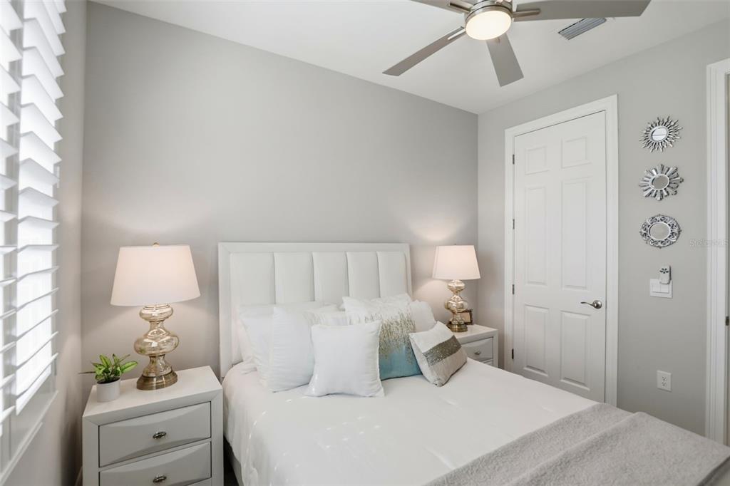 112 Ibiza Loop Venice, FL 34292 - Photo 21 of 35 a bedroom with a bed and a lamp