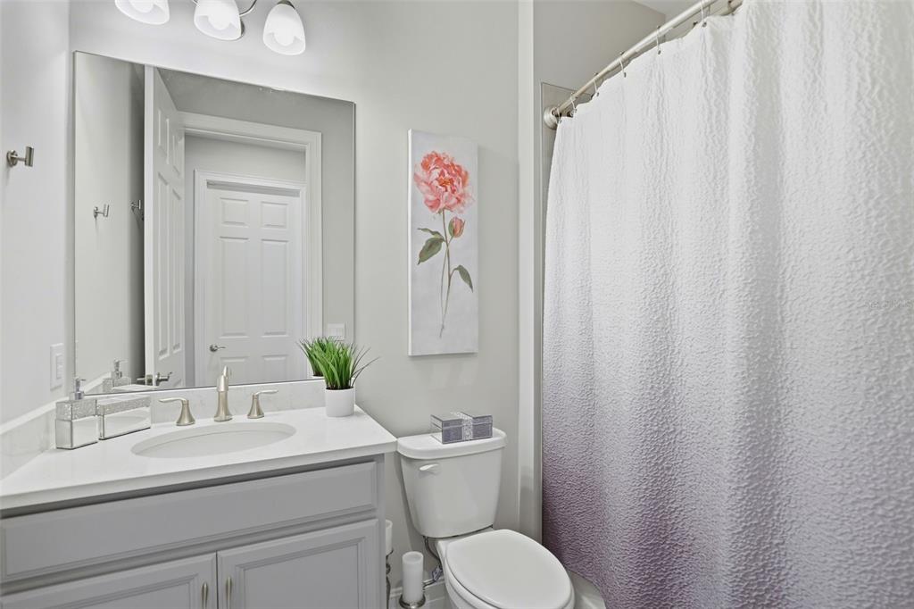 112 Ibiza Loop Venice, FL 34292 - Photo 22 of 35 a bathroom with a granite countertop sink and a toilet