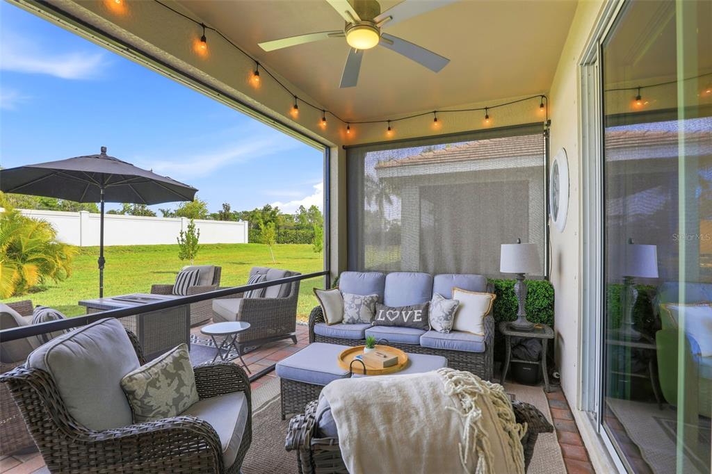 112 Ibiza Loop Venice, FL 34292 - Photo 24 of 35 a living room with furniture and a floor to ceiling window
