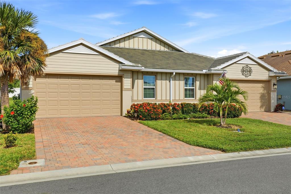 112 Ibiza Loop Venice, FL 34292 - Photo 28 of 35 a front view of a house with a yard and garage