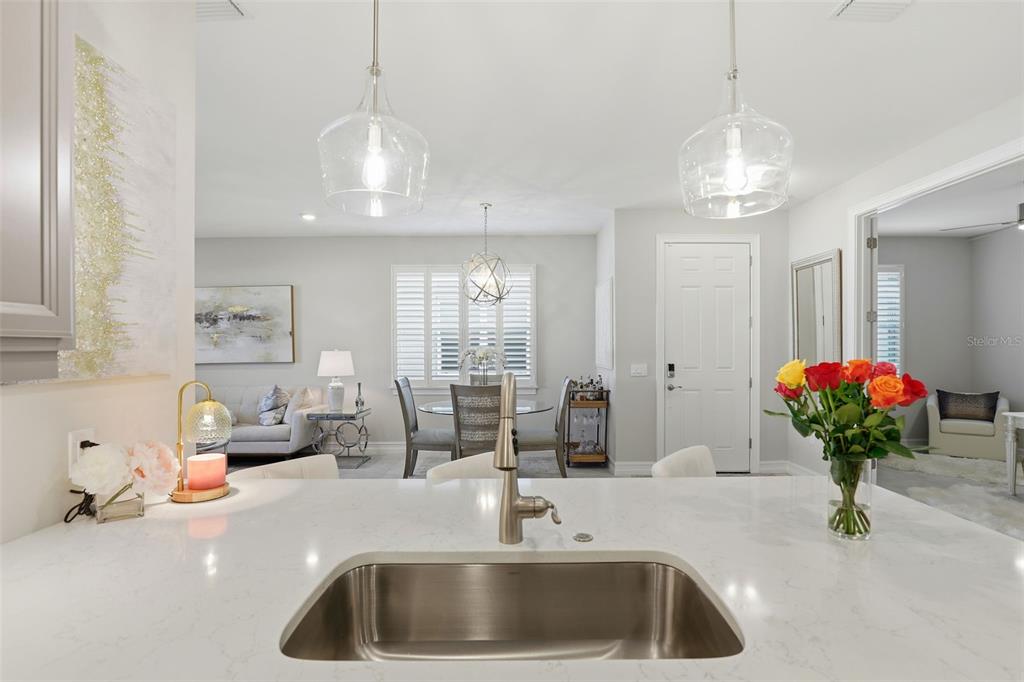 112 Ibiza Loop Venice, FL 34292 - Photo 9 of 35 a kitchen with a sink and chandelier