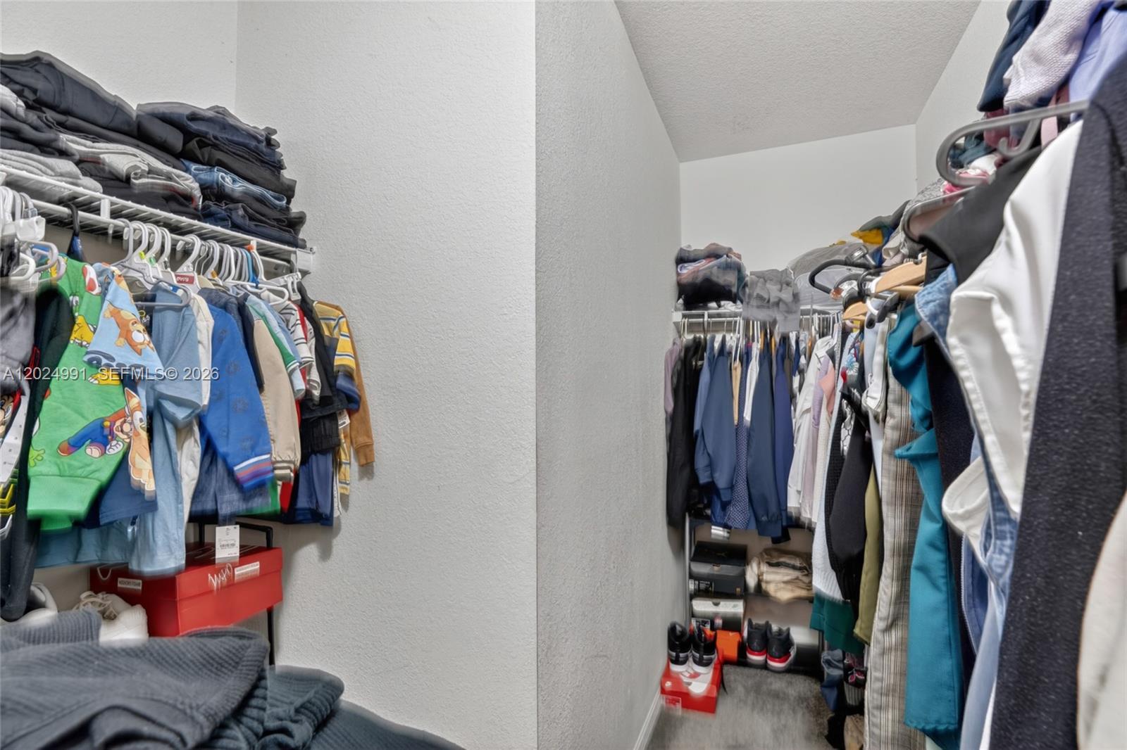 16651 Southwest 79th Terrace Miami, FL 33193 - Photo 24 of 34 a view of walk in closet with clothes and shoes