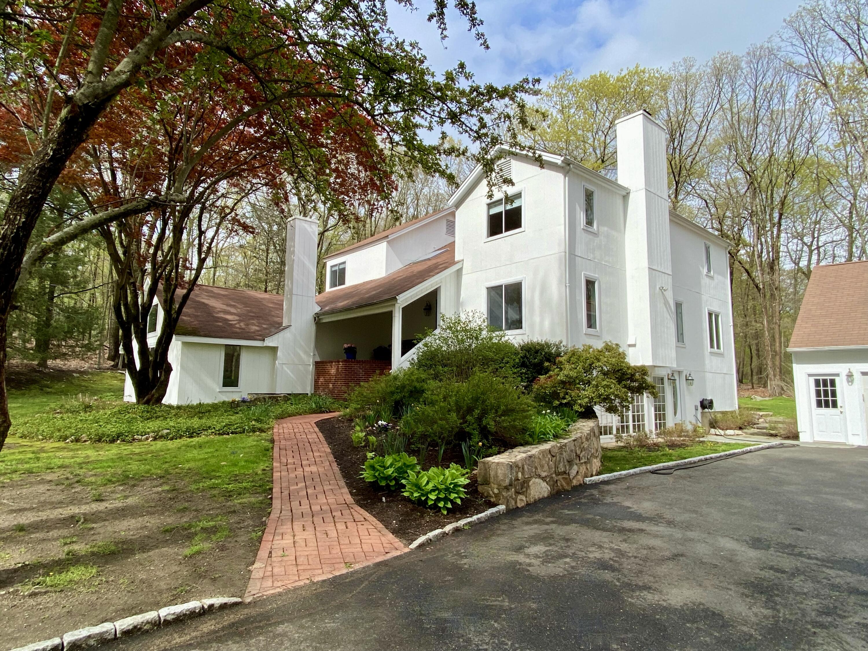 149 Journeys End Road Wilton, CT 06897 - Photo 1 of 30 a front view of a house with a garden