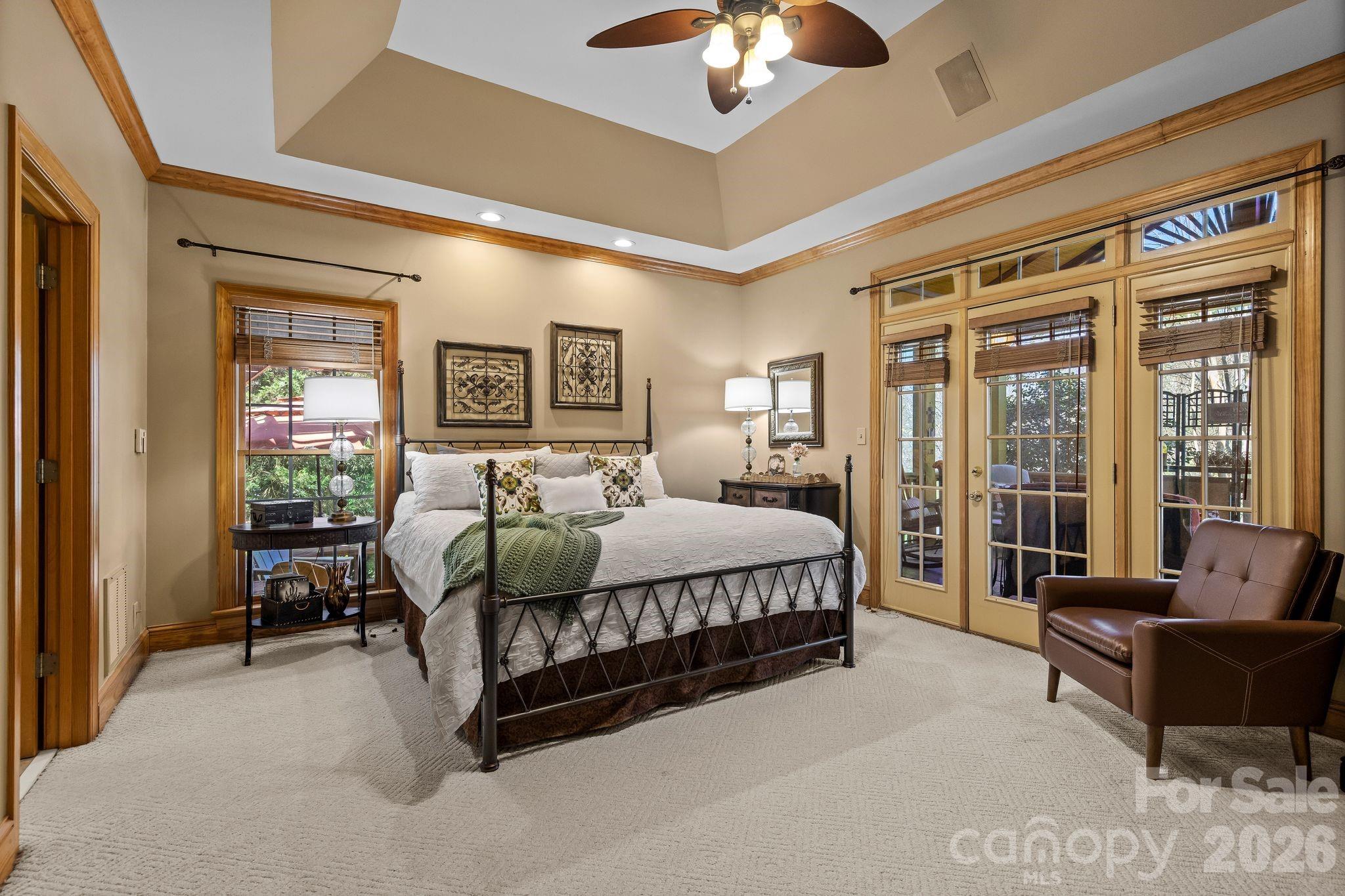 3530 Cardiff Lane Matthews, NC 28104 - Photo 21 of 39 a spacious bedroom with a bed couch and a large window with garden view