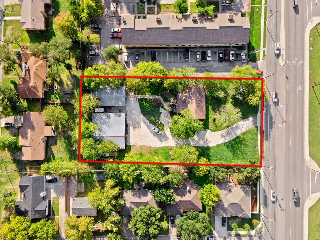 an aerial view of a house with a yard and lake view