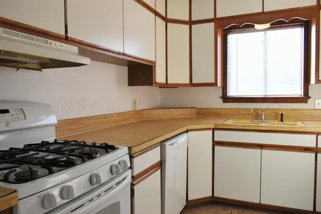a kitchen with a sink cabinets and appliances