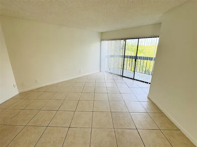 a view of an empty room and a window