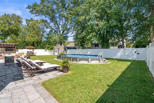 swimming pool view with a seating space