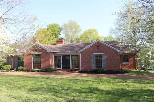a front view of house with yard and green space