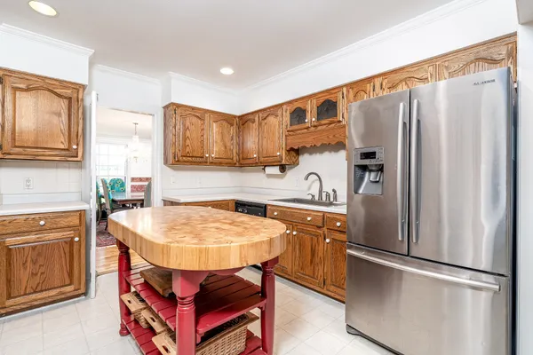 a kitchen with stainless steel appliances granite countertop a refrigerator stove and sink