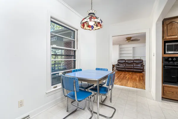 a dining room with furniture and a window