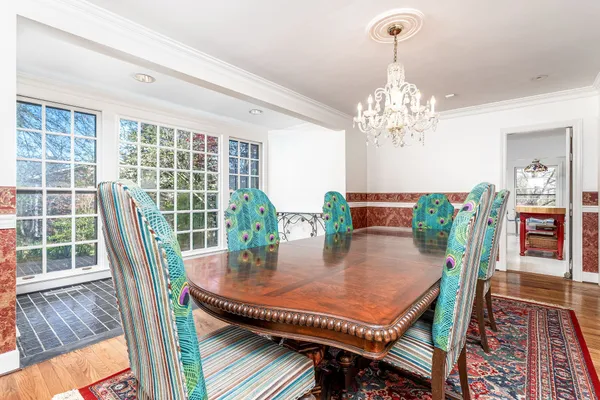 a dining room with furniture a rug and wooden floor