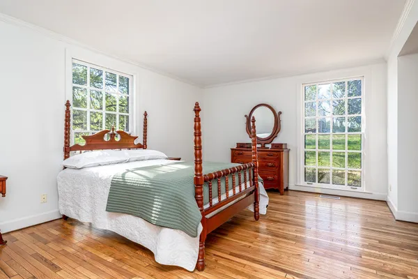 a bedroom with a bed window and a table
