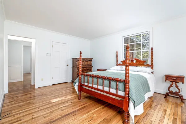 a bedroom with furniture and a window