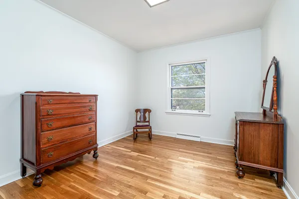 a room with a window and dresser