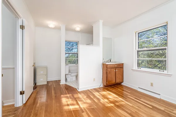 a view of a room with wooden floor and bedroom