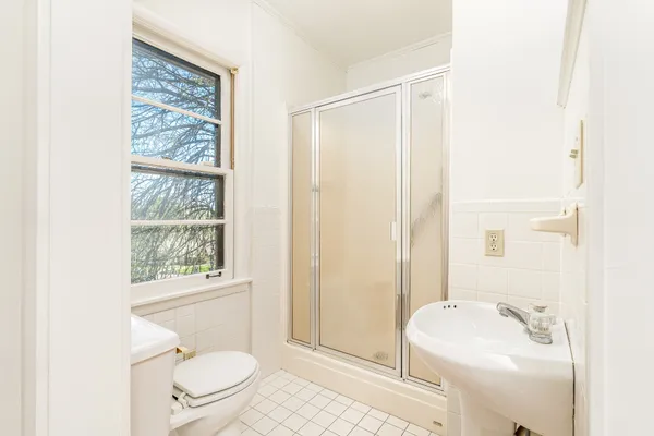 a bathroom with a sink toilet and shower