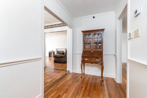 a view of a hallway view with wooden floor and furniture