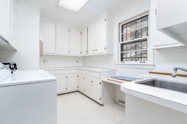 a kitchen with sink cabinets and appliances