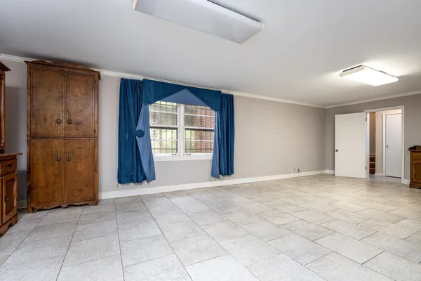 an empty room with windows and closet