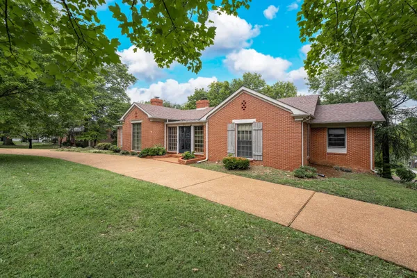 a front view of a house with a garden and porch