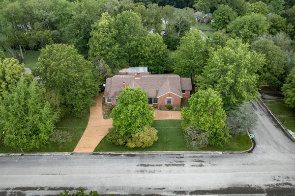an aerial view of a house with outdoor space and street view