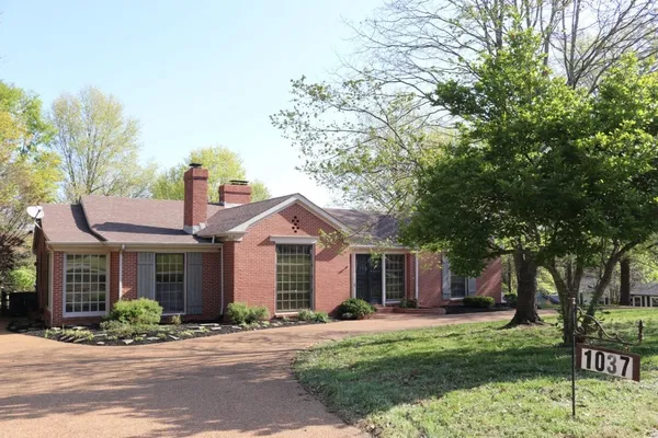 a view of house with yard