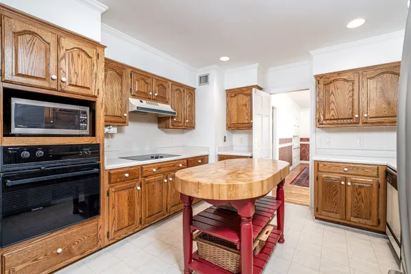a kitchen with stainless steel appliances granite countertop a stove top oven a sink and a refrigerator
