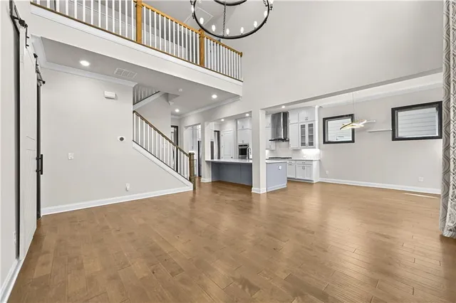 a view of a livingroom with wooden floor and stairs