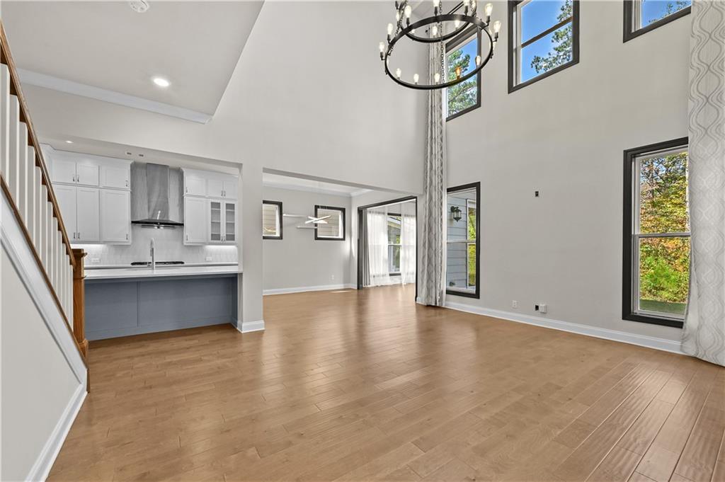 3475 Benedict Place Suwanee, GA 30024 - Photo 12 of 42 a view of an empty room with window and wooden floor