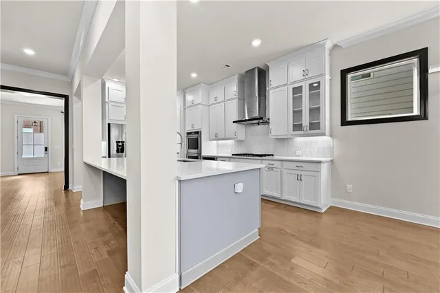 a kitchen with white cabinets and sink