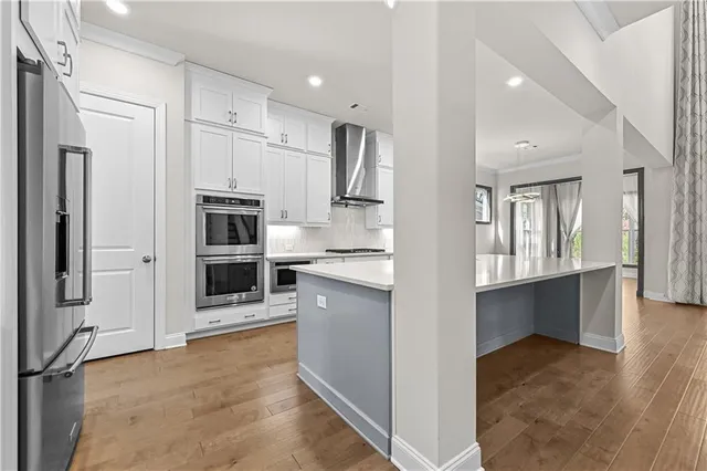 a kitchen with stainless steel appliances a stove and a sink