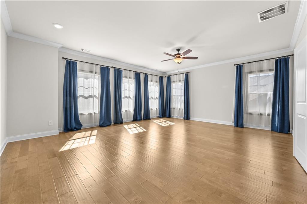 3475 Benedict Place Suwanee, GA 30024 - Photo 31 of 42 a view of an empty room with window and wooden floor