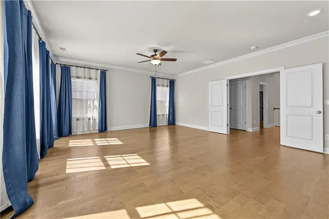 a view of a livingroom with a ceiling fan and window