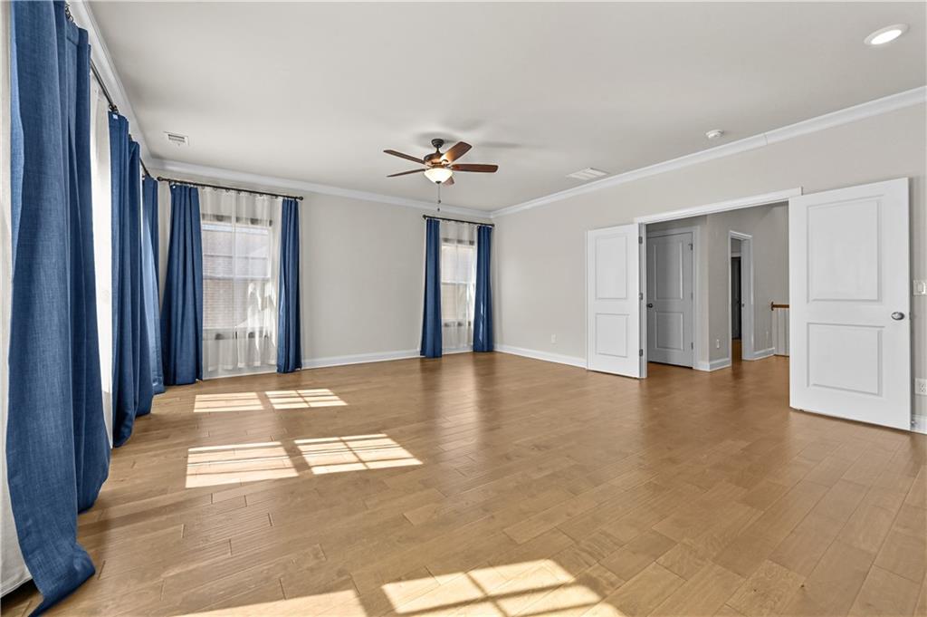3475 Benedict Place Suwanee, GA 30024 - Photo 32 of 42 a view of an empty room with window and a kitchen