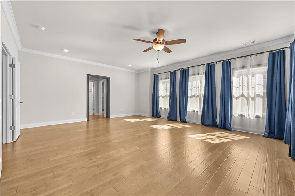 3475 Benedict Place Suwanee, GA 30024 - Photo 33 of 42 a view of a livingroom with a ceiling fan and window