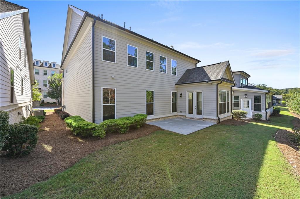 3475 Benedict Place Suwanee, GA 30024 - Photo 38 of 42 a front view of a house with a garden and patio