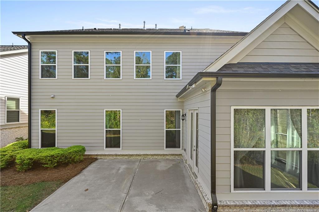 3475 Benedict Place Suwanee, GA 30024 - Photo 39 of 42 a front view of a house with a yard