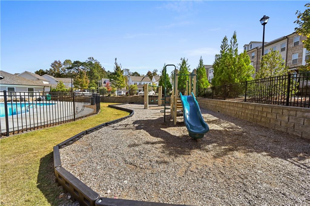 3475 Benedict Place Suwanee, GA 30024 - Photo 42 of 42 a view of a swimming pool with a patio and a yard
