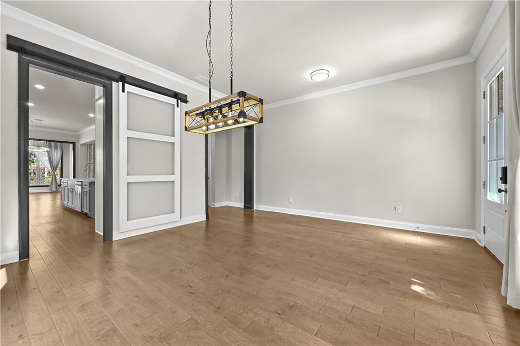 3475 Benedict Place Suwanee, GA 30024 - Photo 8 of 42 a view of an empty room with a chandelier