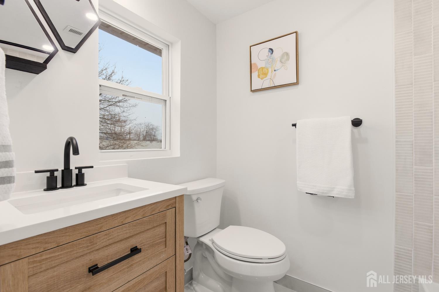 23 Morse Avenue Edison, NJ 08817 - Photo 20 of 31 a bathroom with a toilet sink and mirror