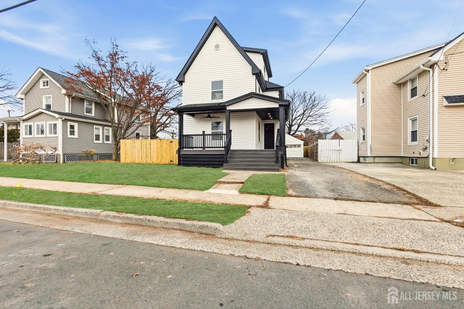 23 Morse Avenue Edison, NJ 08817 - Photo 4 of 31 a view of a white house with a yard and table and chairs next to window