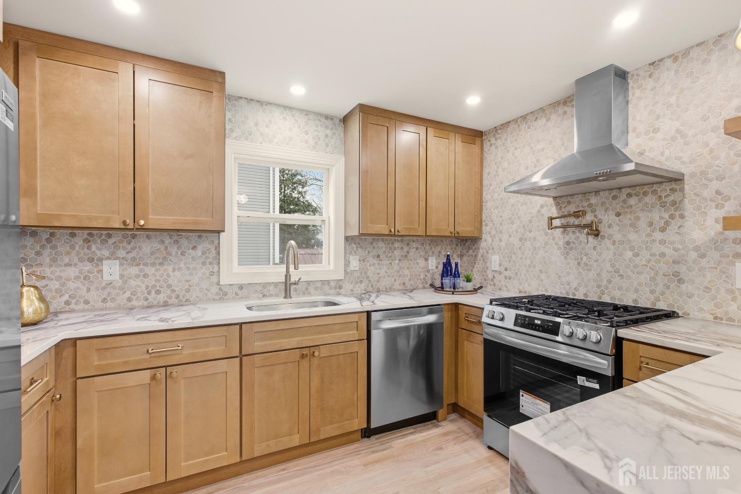 23 Morse Avenue Edison, NJ 08817 - Photo 10 of 31 a kitchen with stainless steel appliances a sink stove and cabinets