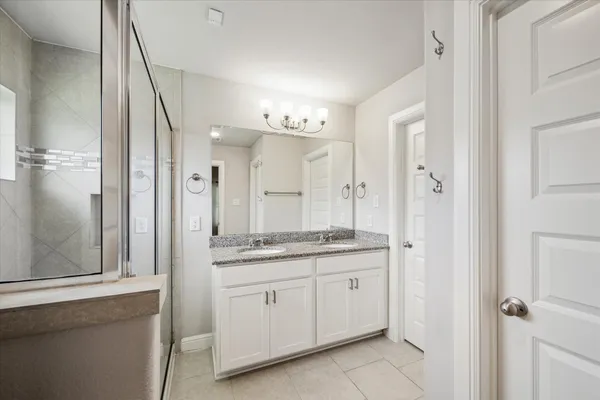 a spacious bathroom with a granite countertop sink a mirror and a