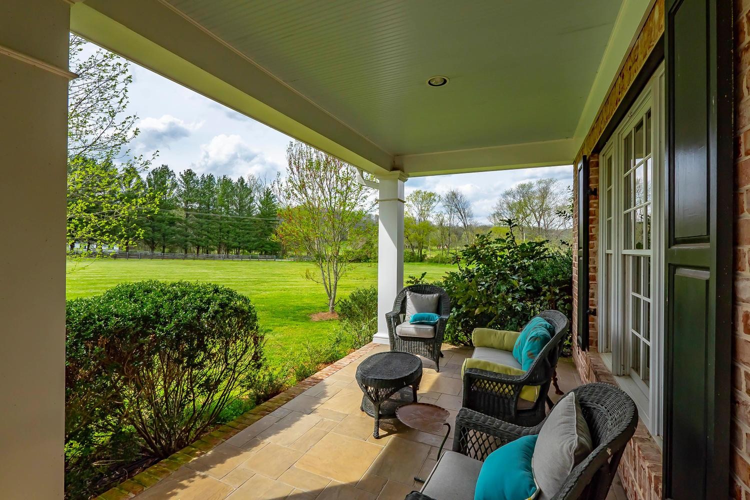 5178 Old Harding Road Franklin, TN 37064 - Photo 3 of 26 a view of a porch with furniture and garden