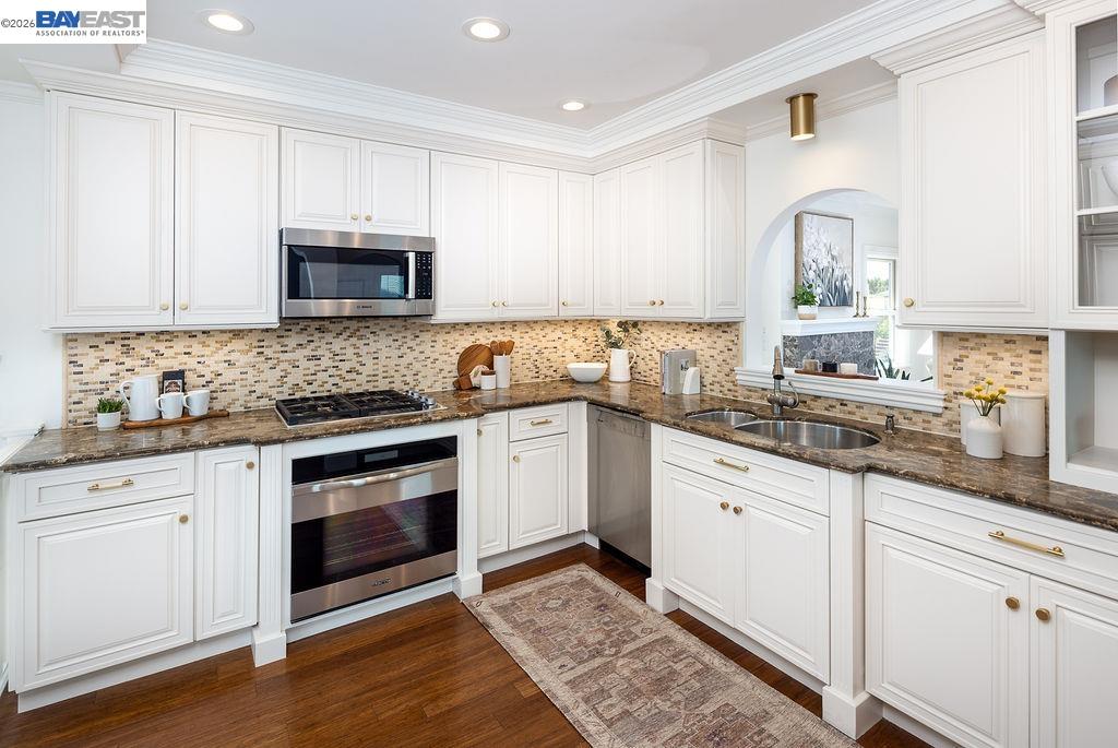1329 Ordway Street Berkeley, CA 94702 - Photo 17 of 47 a kitchen with granite countertop a sink stove and cabinets