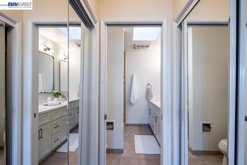 1329 Ordway Street Berkeley, CA 94702 - Photo 27 of 47 a bathroom with a double vanity sink and a mirror