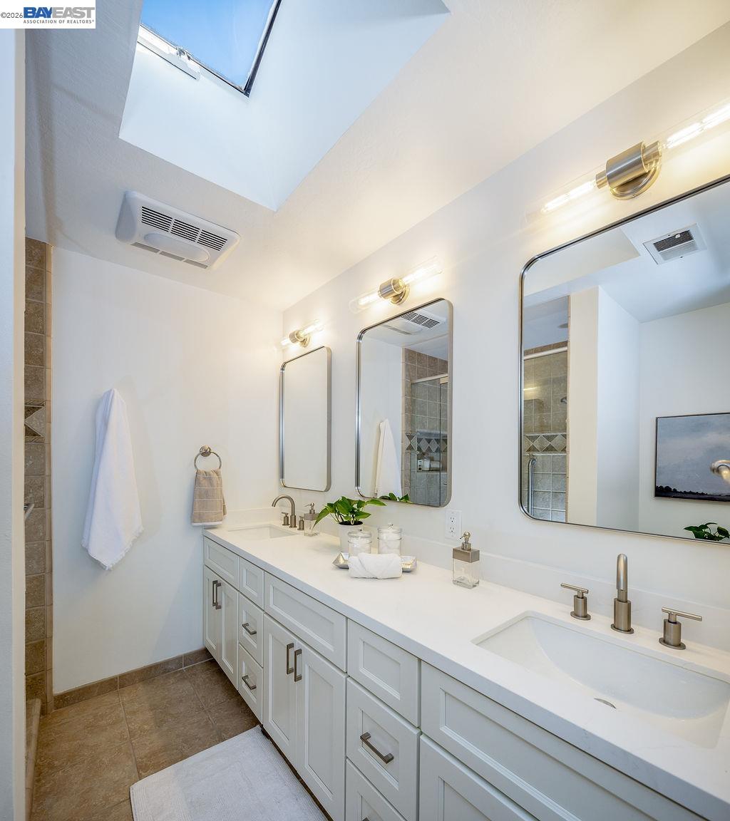 1329 Ordway Street Berkeley, CA 94702 - Photo 28 of 47 a bathroom with double vanity sinks and a mirror