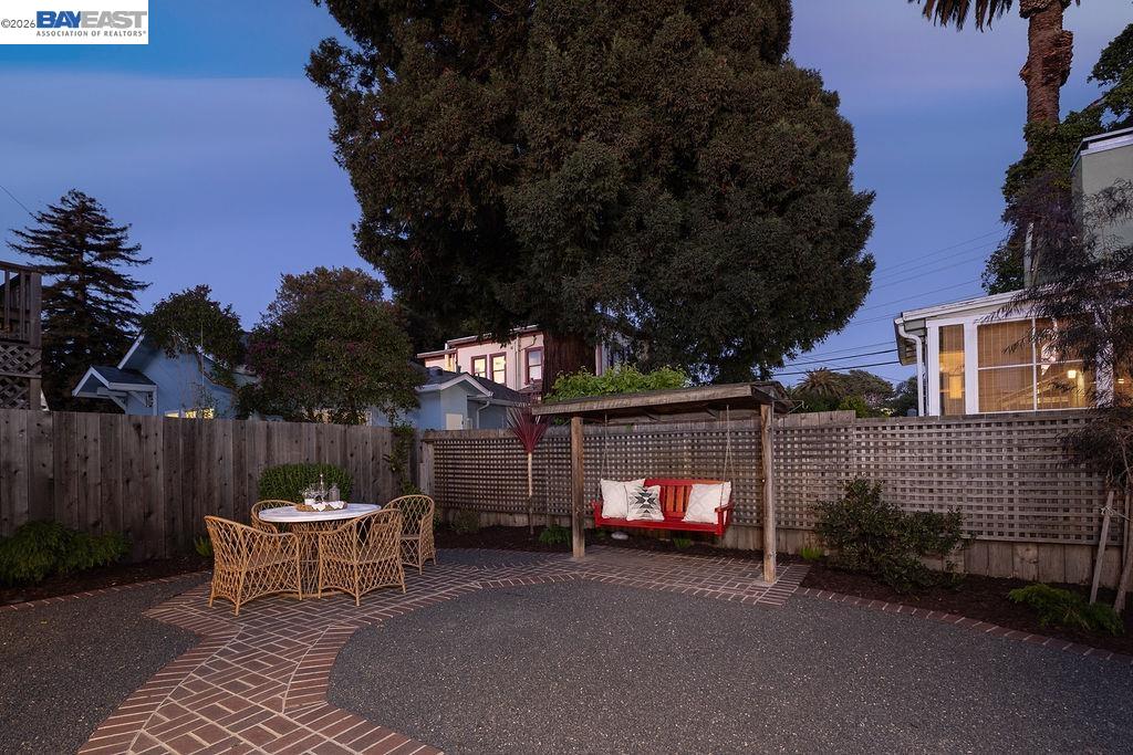1329 Ordway Street Berkeley, CA 94702 - Photo 39 of 47 a view of a patio with a table and chairs and a fire pit