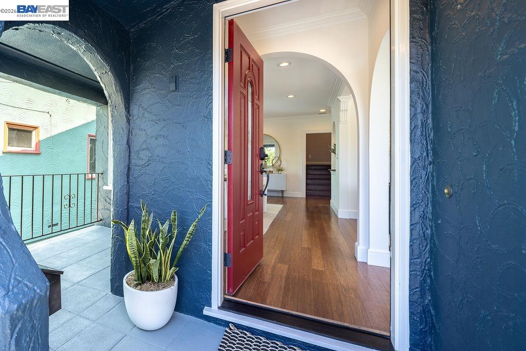 1329 Ordway Street Berkeley, CA 94702 - Photo 7 of 47 a view of a hallway with wooden floor and a potted plant